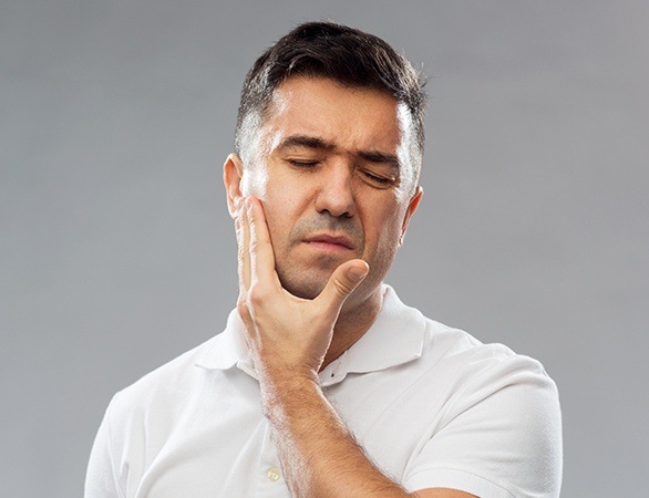Man holding jaw after knocking out tooth
