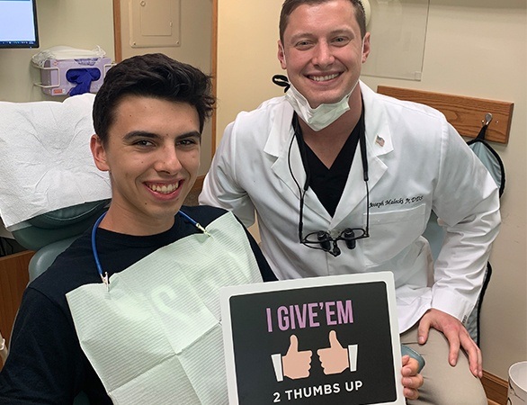 Dr. Malecki and dental patient smiling after dental checkup