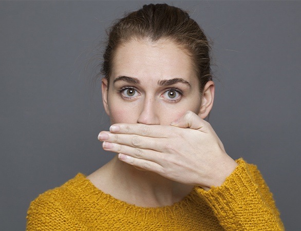 Woman covering her  mouth