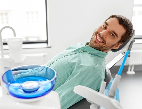 Dental patient smiling in dental exam room