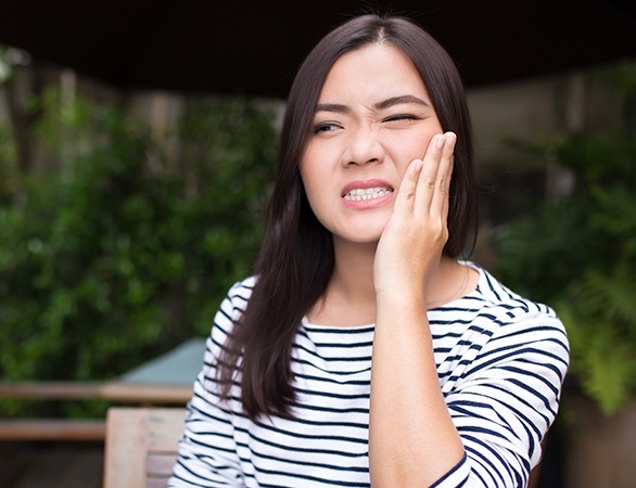 Woman with toothache holding cheek