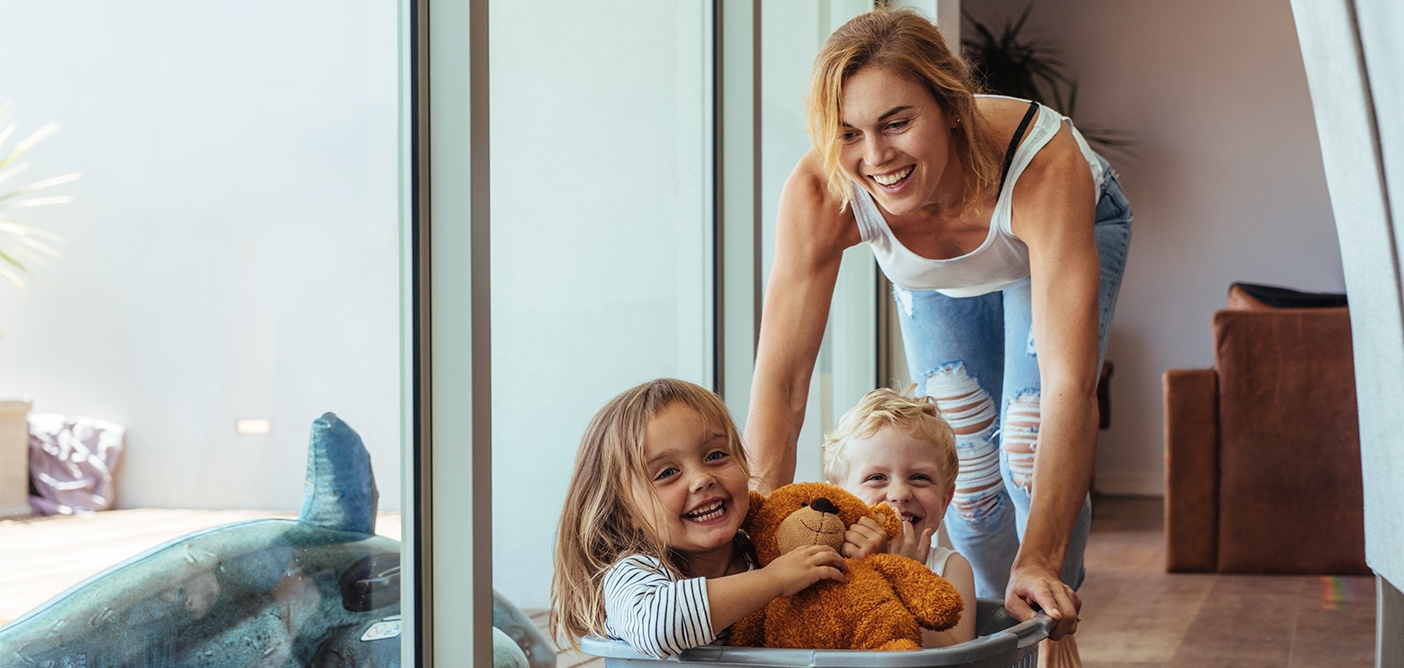 Mother and two kids with healthy smiles thanks to family dentistry