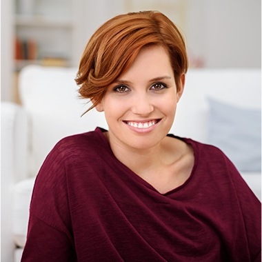 Woman in red sweater smiling