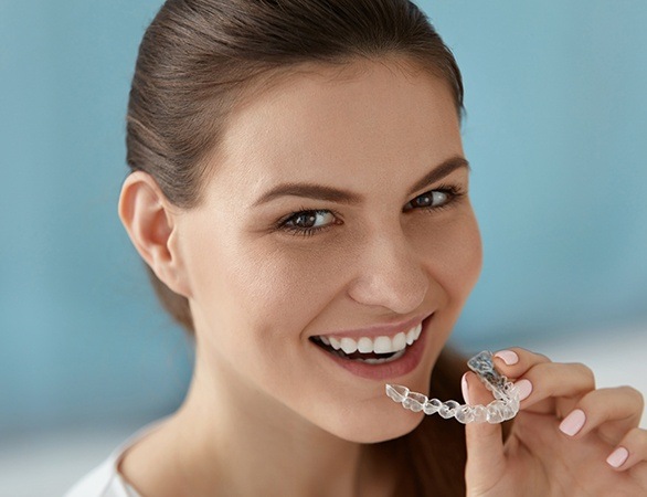 Woman placing invisalign tray