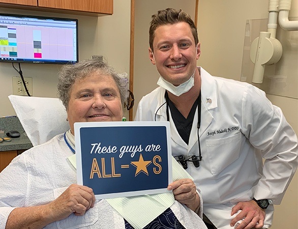 Dr. Malecki and patient smiling together