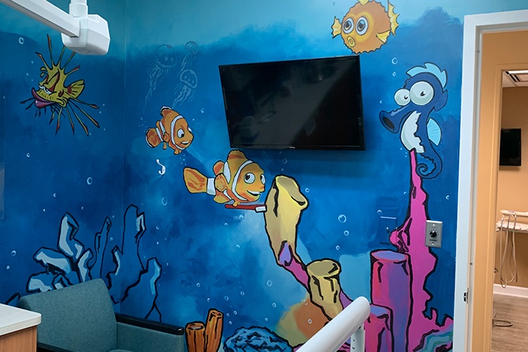 Mural of fish on wall in kid friendly dental exam room