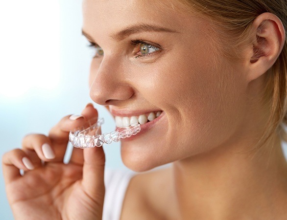 Woman placing Invislaign tray