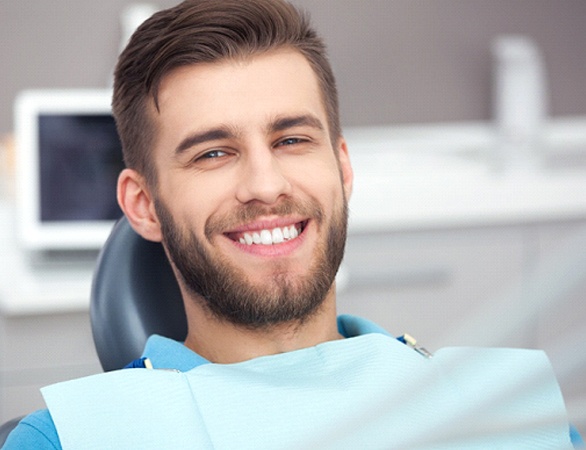 Happy male dental patient after treatment on Saturday