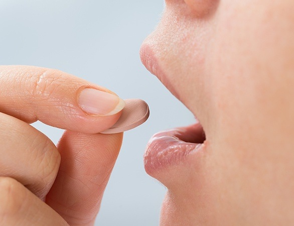 Patient taking an oral sedative pill