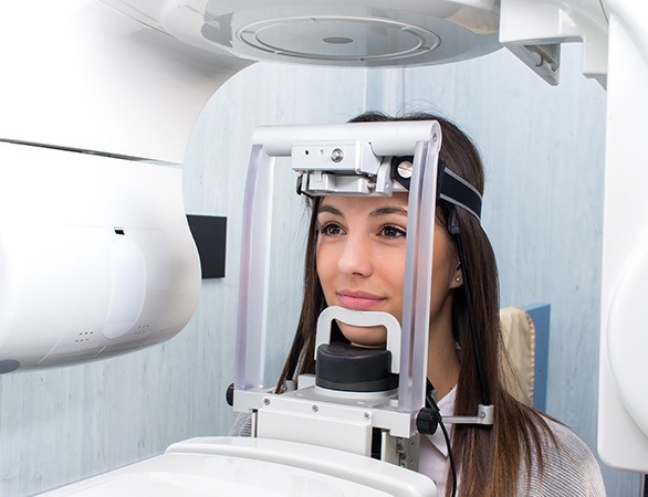 Woman receiving 3 D C T scan of her mouth and jaw
