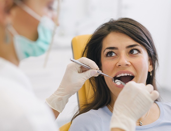 Woman receiving tooth extraction